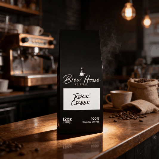 Rock Creek medium roast coffee blend 12oz bag on wooden counter with coffee beans and espresso machine background